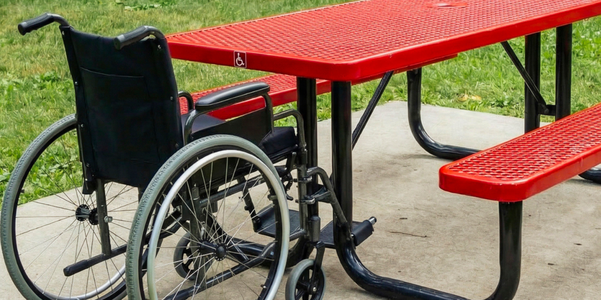 ADA accessible red expanded metal rectangular picnic table with wheelchair seating space and heavy-duty powder-coated steel frame designed for inclusive commercial outdoor furniture installations