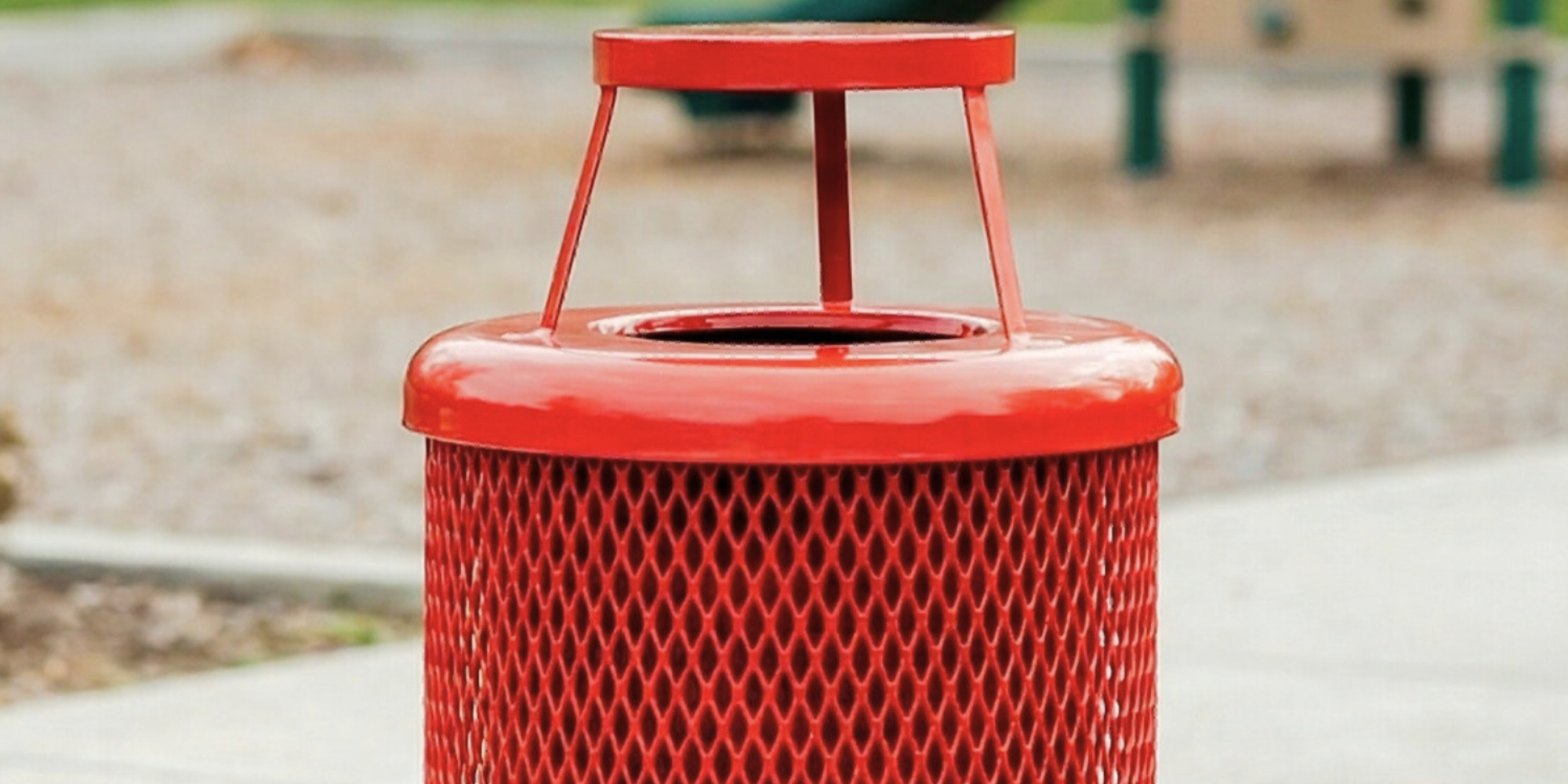 Heavy-duty red expanded metal outdoor trash receptacle with protective bonnet lid and powder-coated steel construction designed for durable commercial waste disposal systems