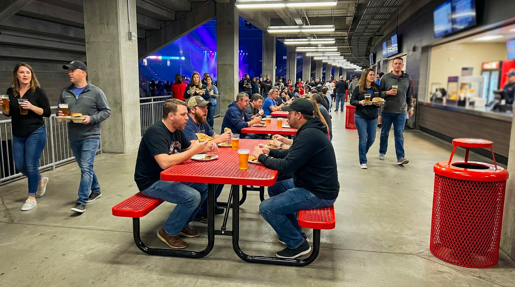 Red 6 Ft rectangular expanded metal picnic table with commercial-grade steel frame and coordinating trash receptacle for high-traffic indoor venue seating