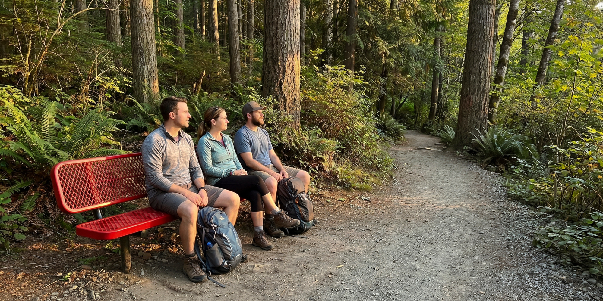 Heavy-duty red expanded metal park bench with powder-coated steel frame designed for durable outdoor seating along public trails, parks, and recreation areas