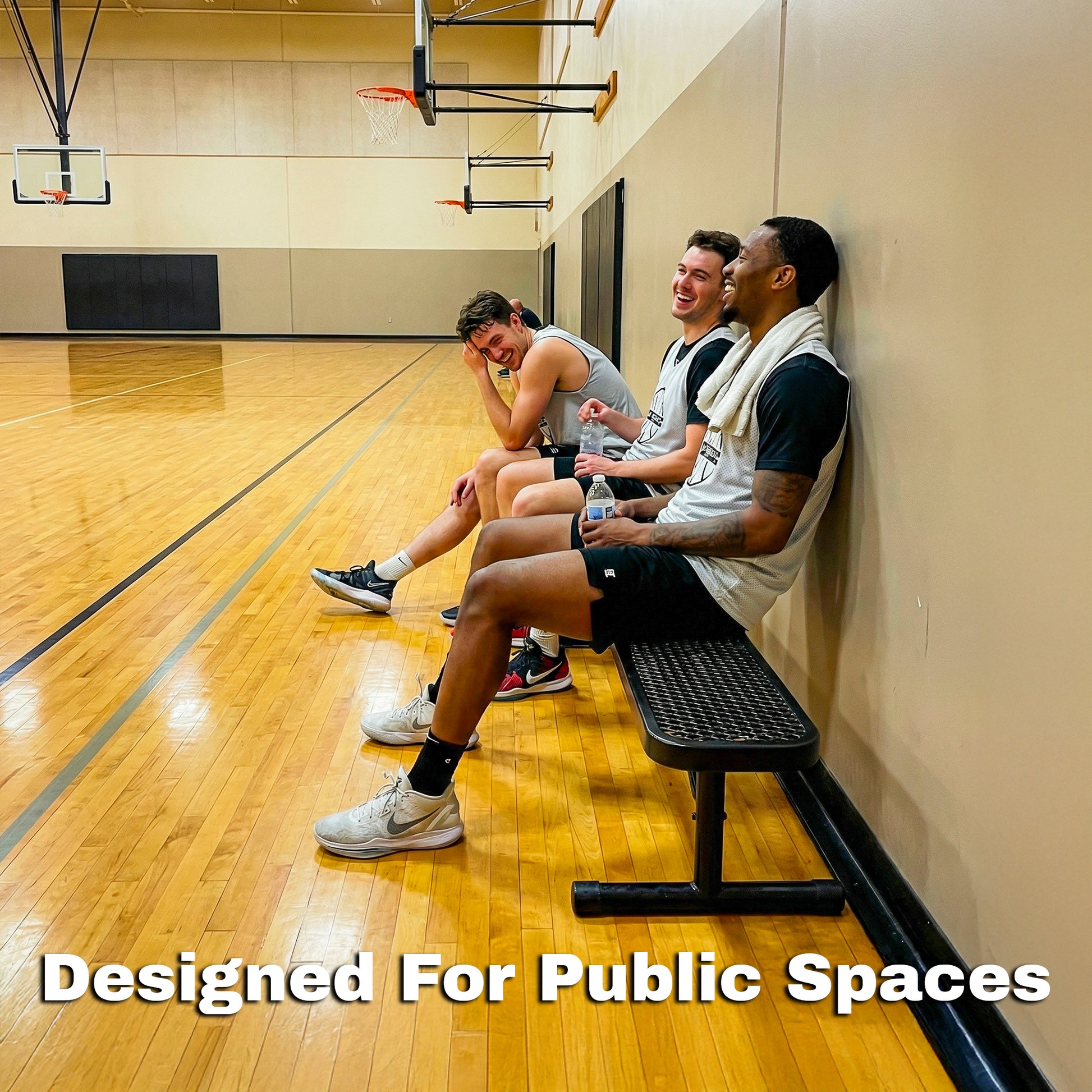 Three men sitting on a bench in a gymnasium with text 'Designed For Public Spaces'.