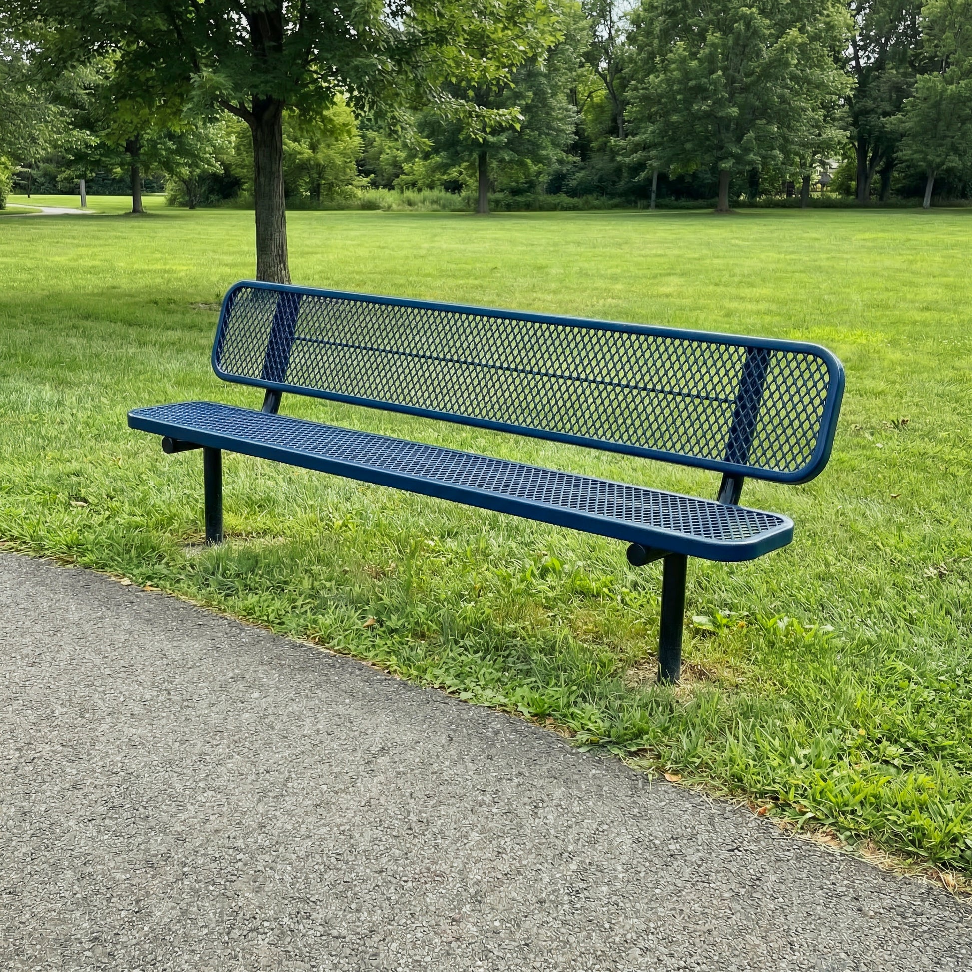 Blue metal bench in a park setting with green grass and trees.