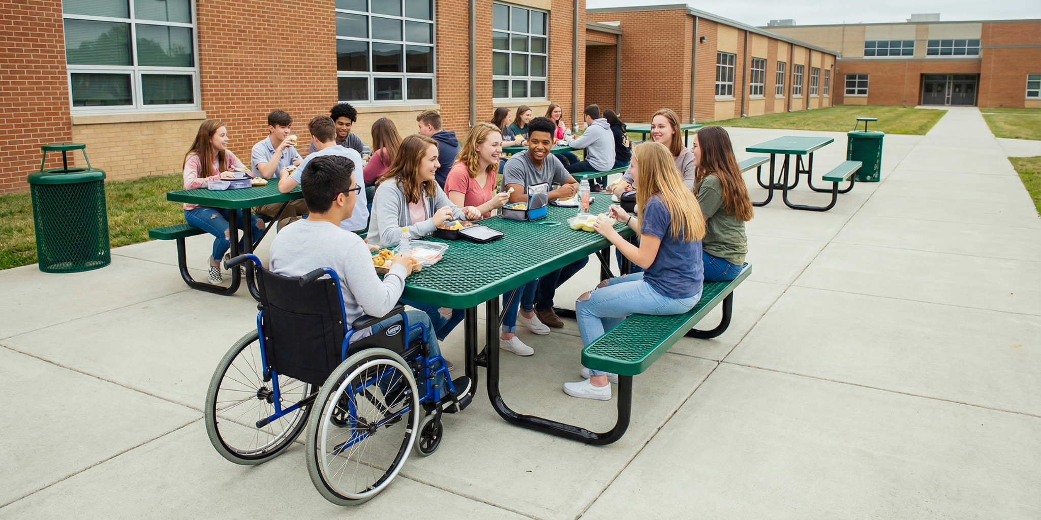 Green ADA accessible heavy duty  rectangular expanded metal picnic table with commercial steel construction and wheelchair clearance for outdoor campus dining