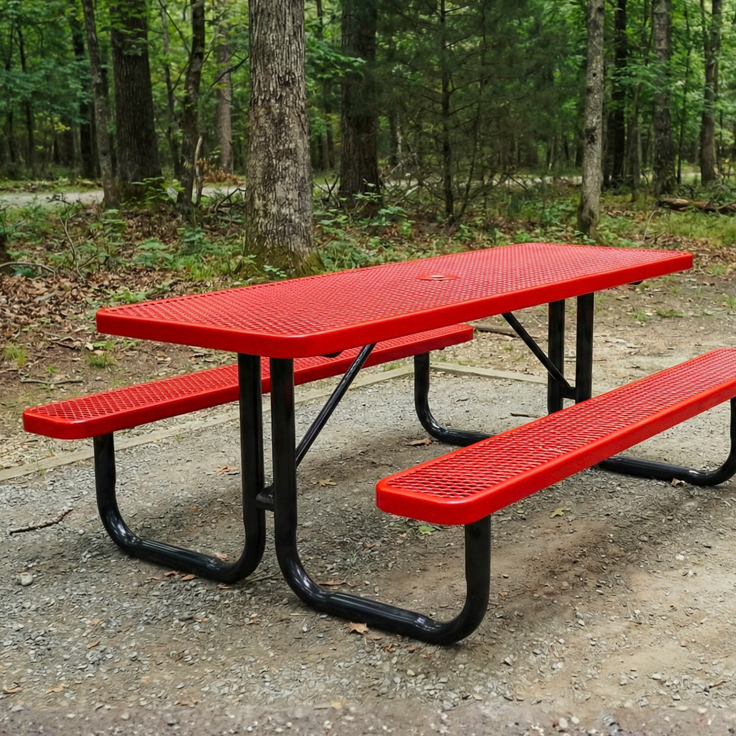 Red picnic table with black metal legs in a forest setting