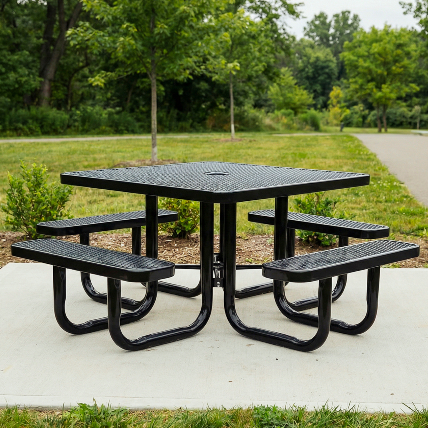 Black square metal picnic table with four benches in a park setting