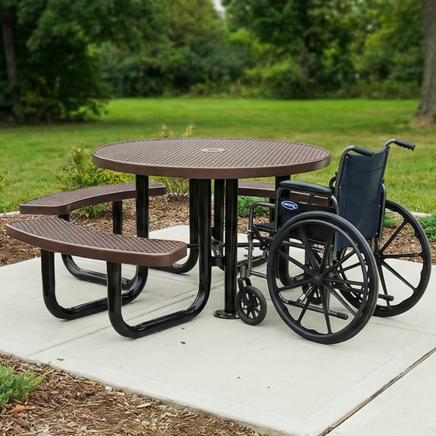 Wheelchair next to a round ADA outdoor table in a park setting