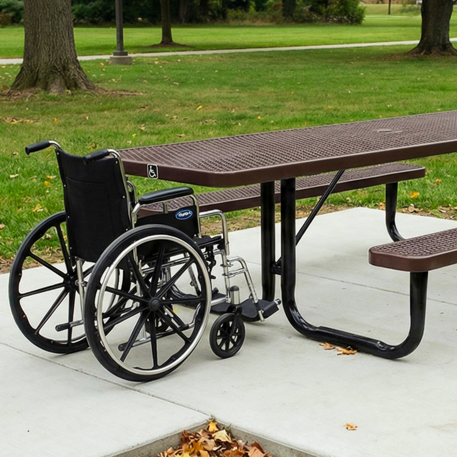 Wheelchair next to an ADA picnic table in a park setting