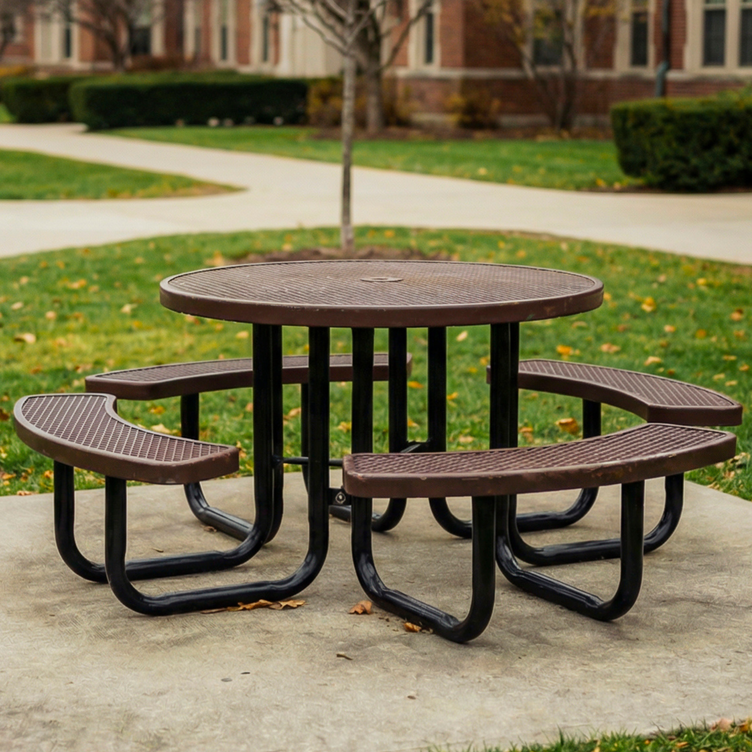 Picnic table with benches on a concrete patio in an outdoor setting area in a university