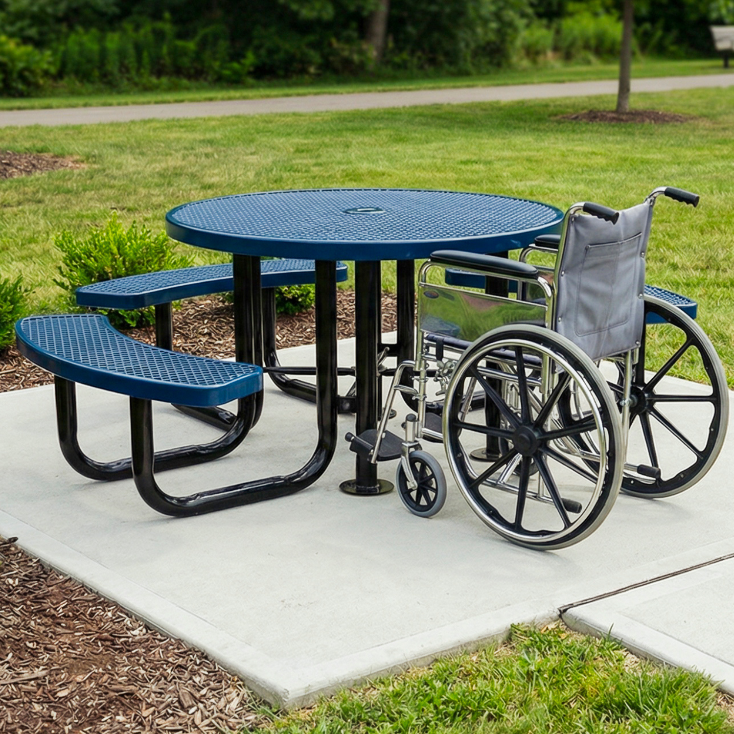 Blue ADA picnic table with wheelchair and benches in a park setting