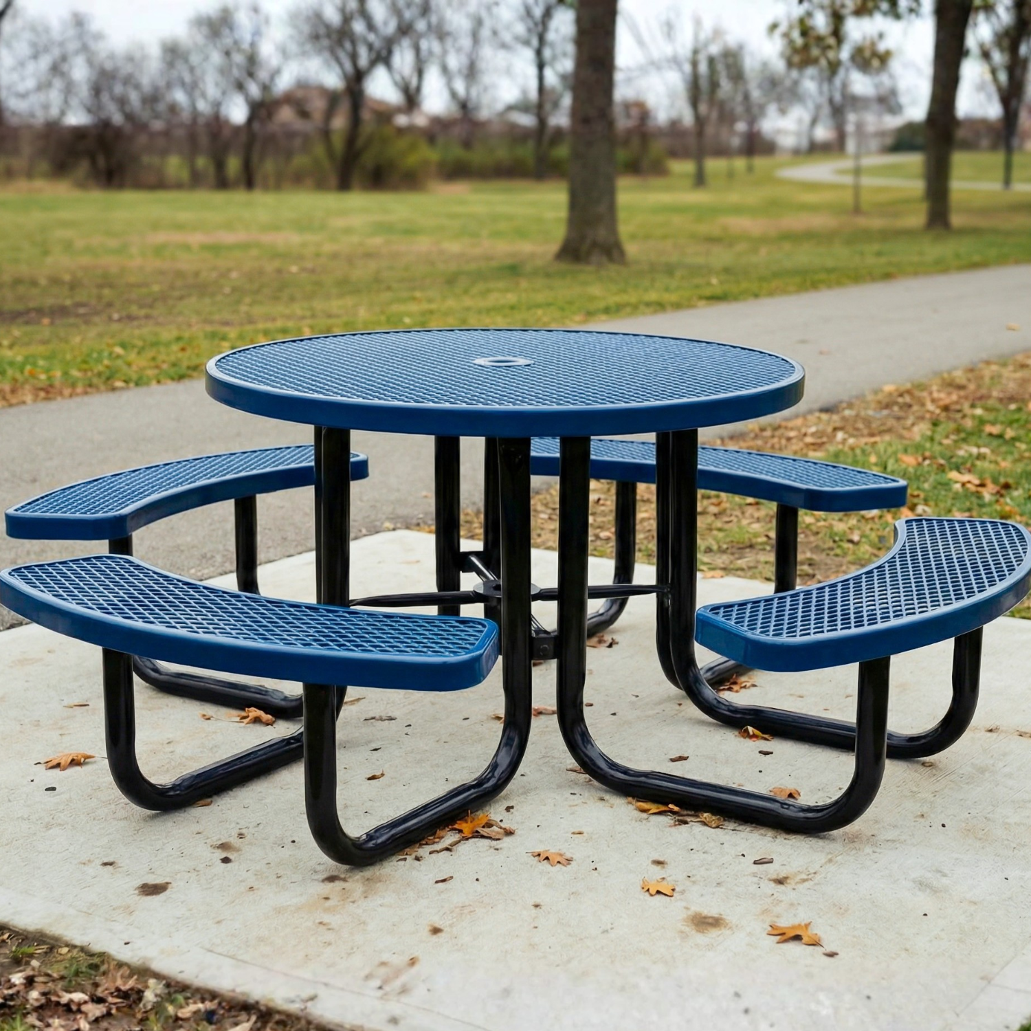 Blue metal picnic table with four seats in a park setting