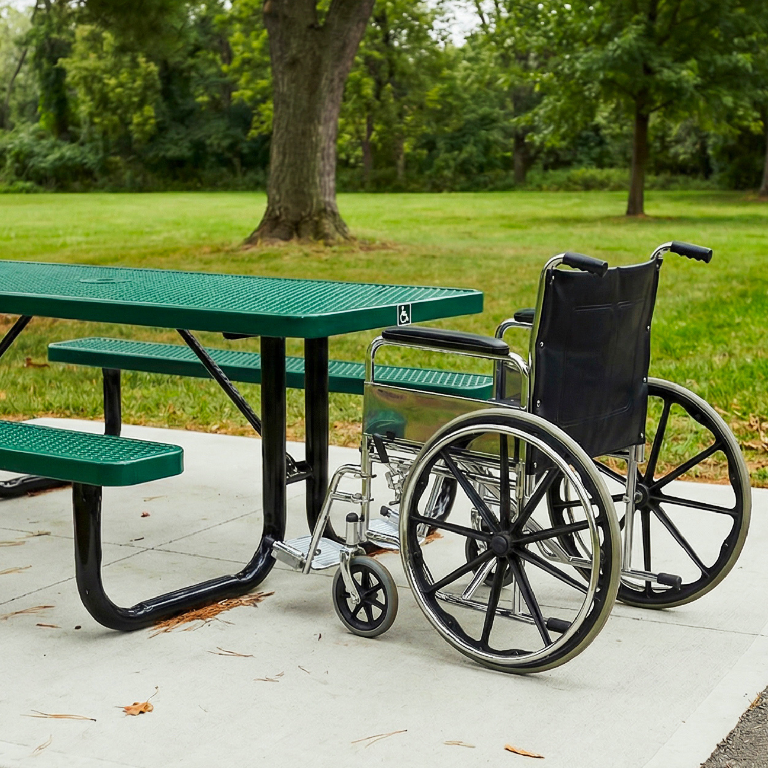 Wheelchair parked next to a green picnic table in a park setting