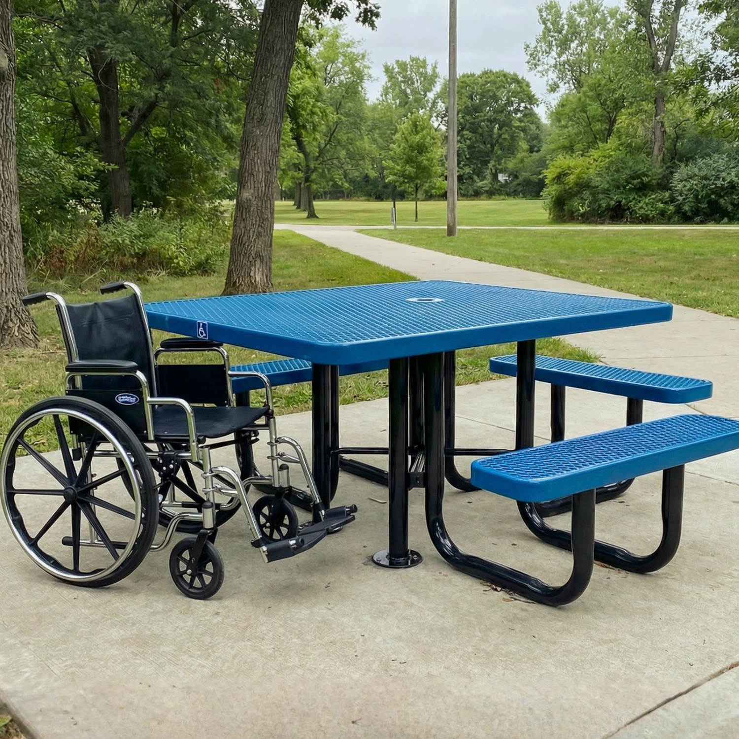Blue picnic table with wheelchair accessible features in a park setting