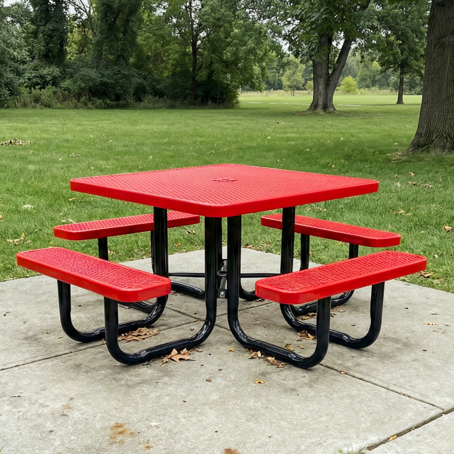 Red square picnic table with black legs in a park setting