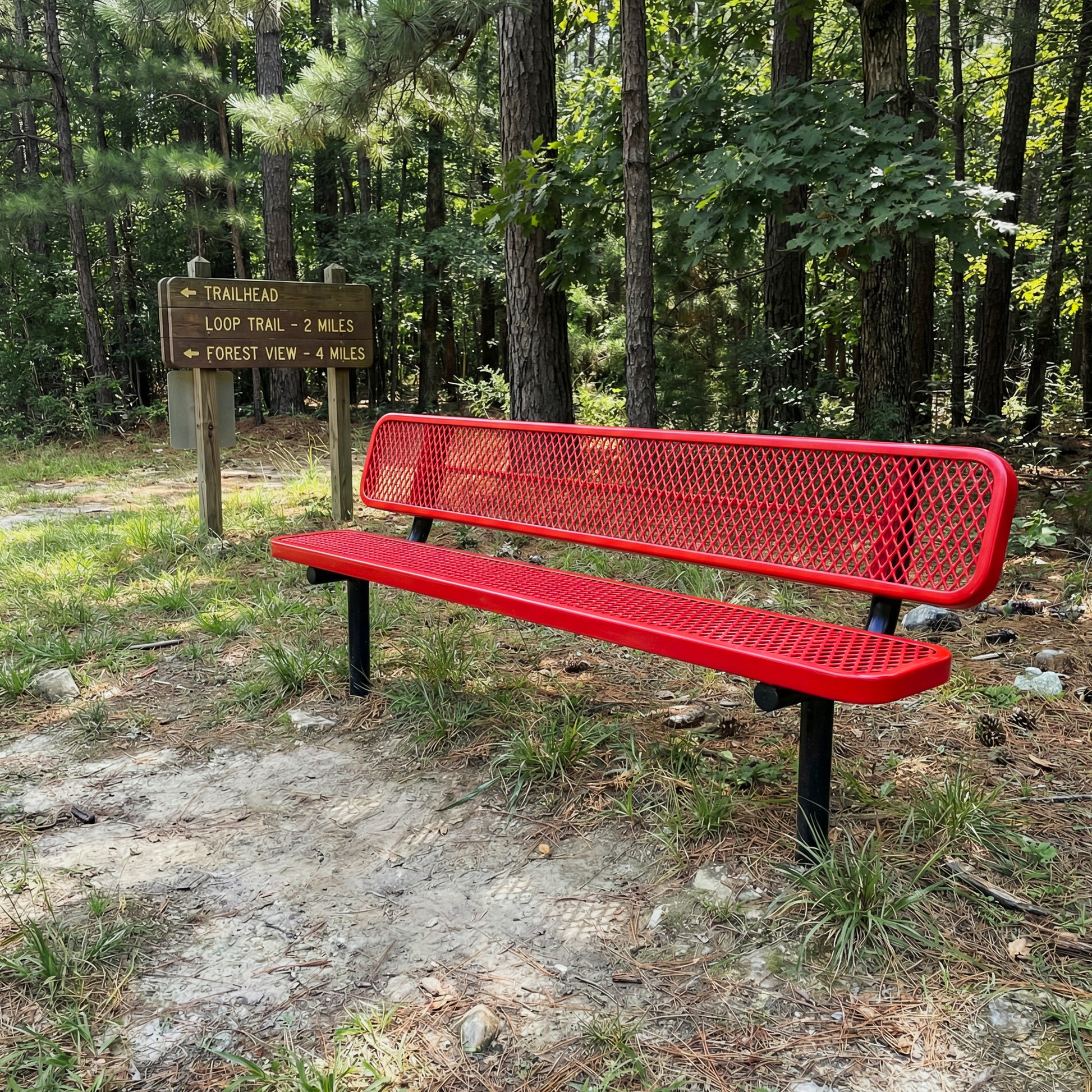 Red in ground bench on the side of a hiking trail