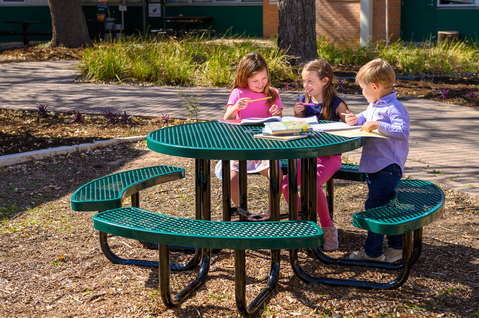 Children sitting on playground picnic table made of steel and high-quality materials that will stand the test of time.